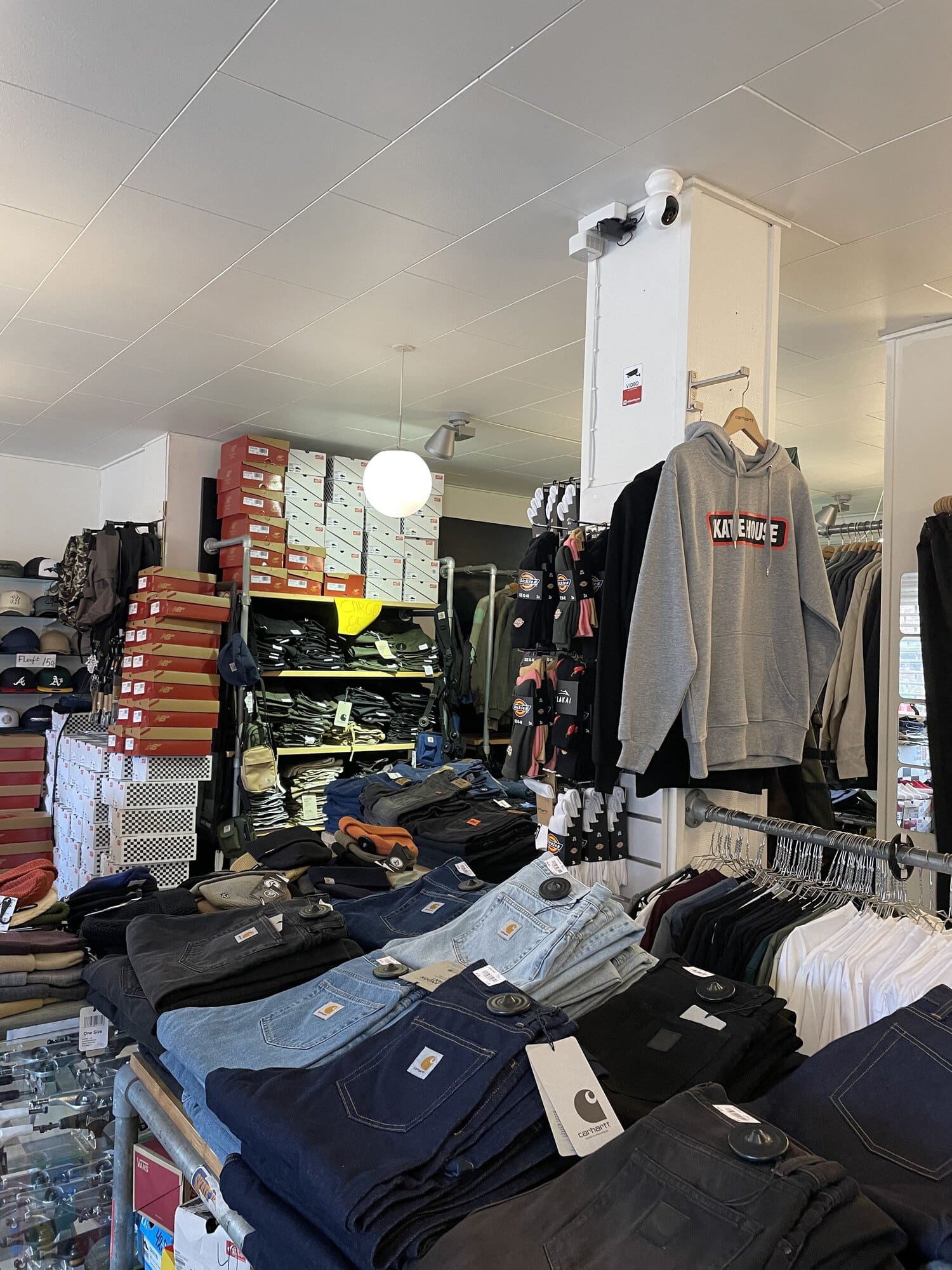 Jeans på bordet og en grå Skate House-hoodie i butikken